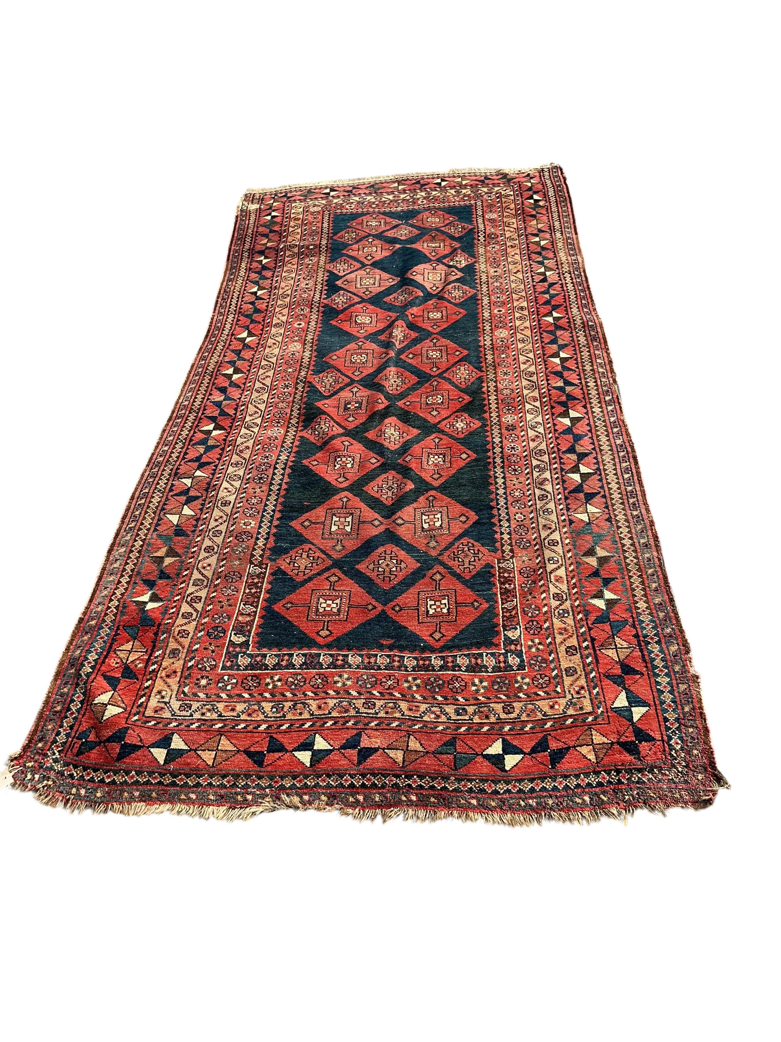 A Belouch blue ground hall carpet, 325cm x 145cm